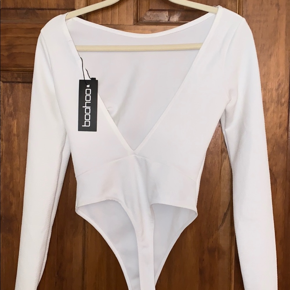 Brand new backless creme long sleeve bodysuit
